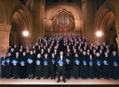 Full choir on stage with conductor